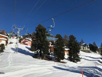 Overhead cable car against sky during winter