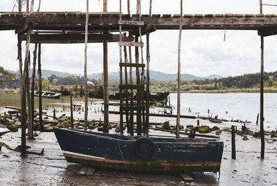 Boats moored on river against sky