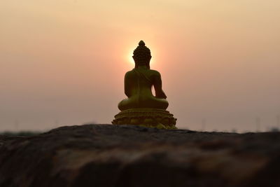 Low angle view of statue against sky during sunset