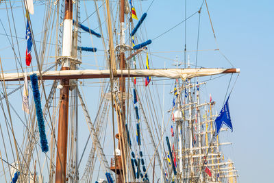 Low angle view of masts against clear sky