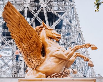 Low angle view of statue against buildings