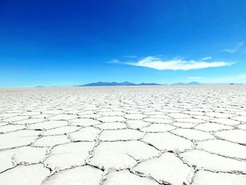 Scenic view of landscape against blue sky