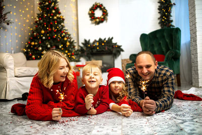 Portrait of happy family sitting on sofa at home