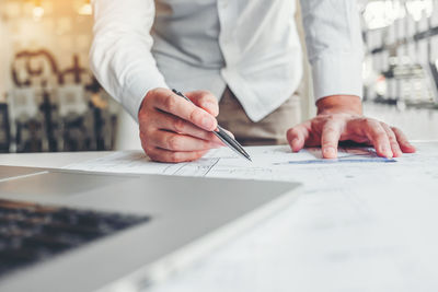 Midsection of businessman working at office