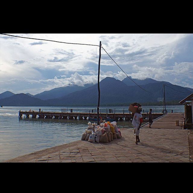 mountain, sky, water, mountain range, sea, cloud - sky, scenics, lifestyles, leisure activity, pier, men, tranquil scene, cloud, beauty in nature, nature, nautical vessel, tranquility, lake, person