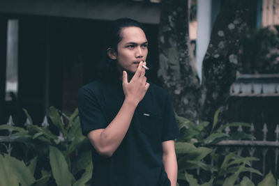 Young man smoking cigarette