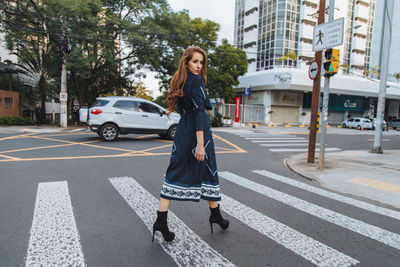 Full length of man crossing road