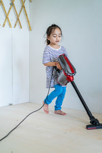 Full length of boy playing on tiled floor