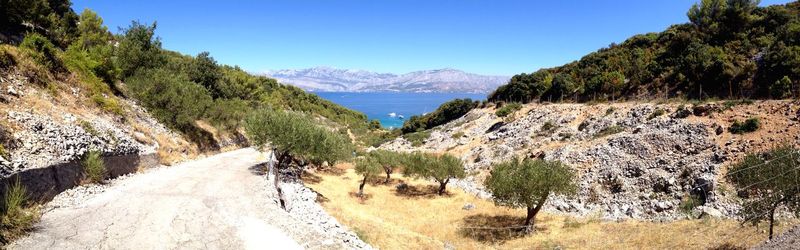 Panoramic view of mountains against clear blue sky