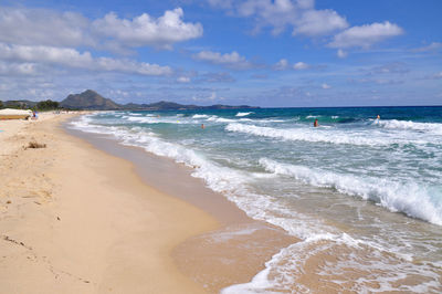 Scenic view of sea by mountains against clear sky