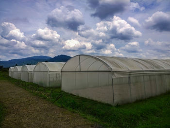 Scenic view of field against cloudy sky