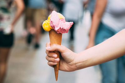 Close-up of hand holding ice cream