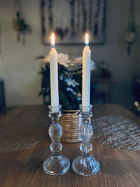 Close-up of illuminated candles on table at home