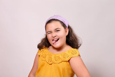 Portrait of a smiling girl against white background