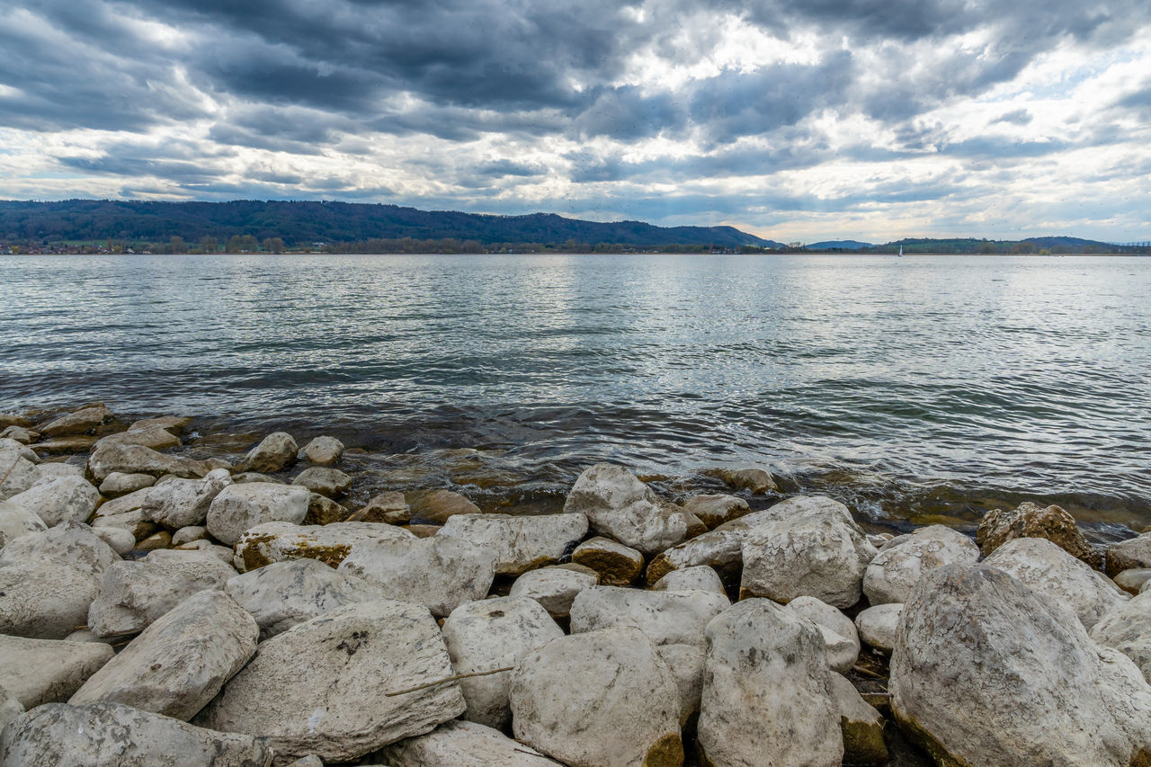 SCENIC VIEW OF SEA AND ROCKS AGAINST SKY