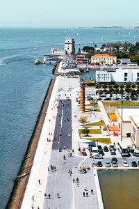 High angle view of buildings by sea against sky