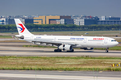 Airplane on runway against sky