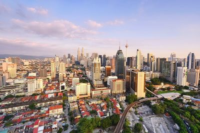 View of cityscape against cloudy sky