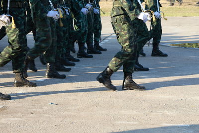 Low section of soldiers walking on street