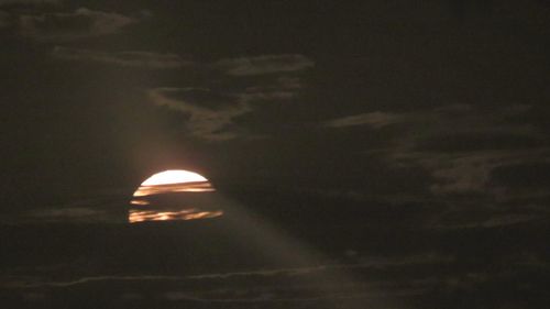 Low angle view of moon at sunset