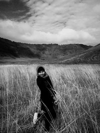 Man standing on field against sky