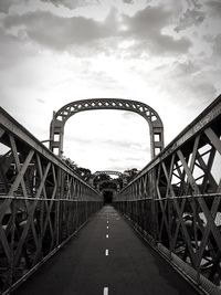 Bridge over road against sky