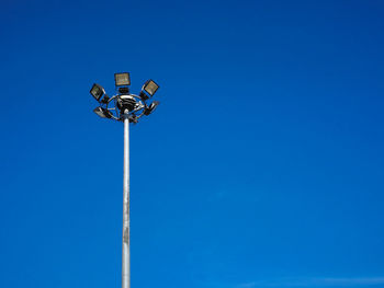 Low angle view of street light against clear blue sky