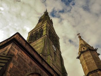 Low angle view of building against cloudy sky