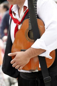 Close-up of midsection of man with guitar