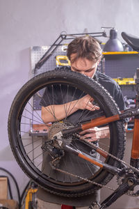 Reflection of man and bicycle on mirror