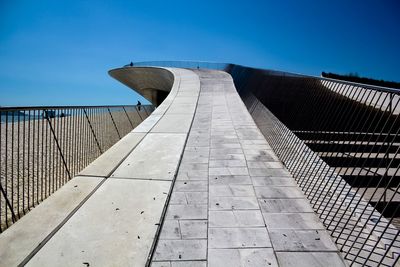 Low angle view of bridge against clear blue sky