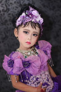 Portrait of cute girl with purple flower