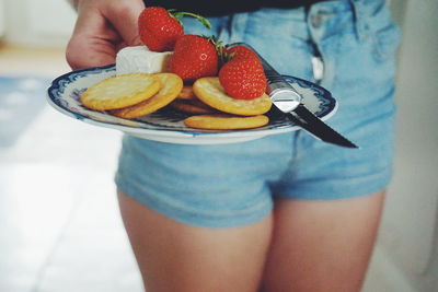 Low section of person holding fruits