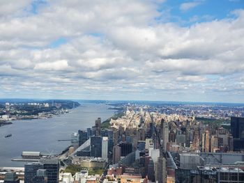 High angle view of buildings against cloudy sky