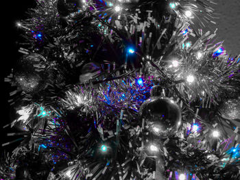 Low angle view of illuminated christmas tree at night