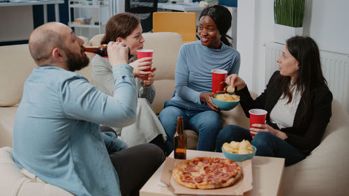 Business colleagues having food after office hours