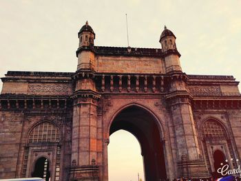 Low angle view of gateway to india against sky in city