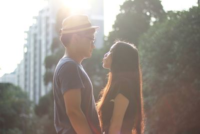 Young romantic couple standing face to face in city