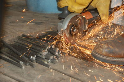 Low angle view of man working on metal