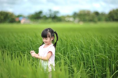 Cute girl standing in field