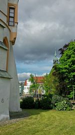 Buildings against cloudy sky