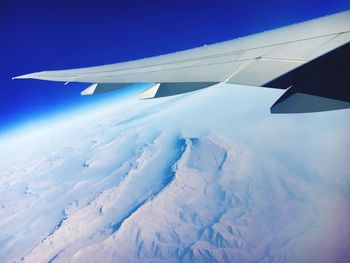 Cropped image of airplane flying over landscape