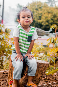 Portrait of boy sitting on field