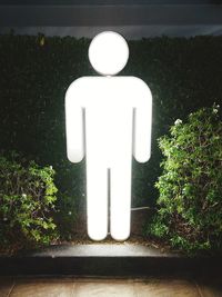 White sign on plant in park