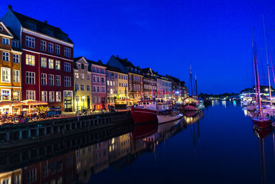 Boats moored at harbor