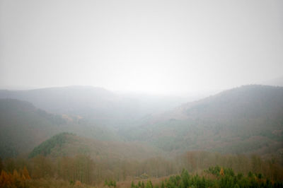 Scenic view of mountains in foggy weather