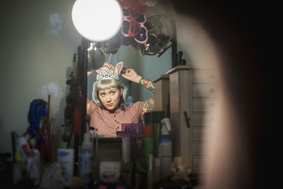 Young woman in front of mirror