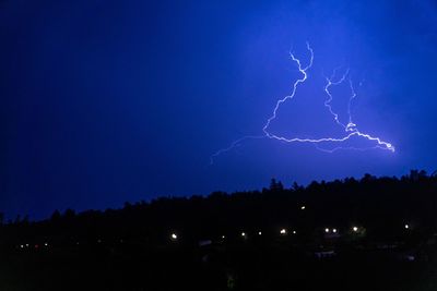 Low angle view of lightning in sky at night