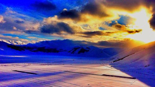 Scenic view of landscape against cloudy sky