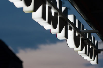 Low angle view of store sign against sky